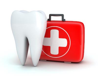 Tooth next to first aid kit at emergency dentist in Champaign, IL