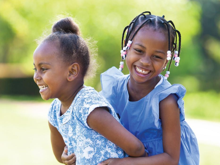 Two young sisters playing outside near childrens dentist in Champaign IL