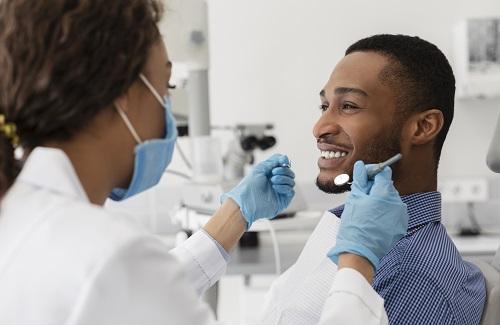 Man smiling during dental exam in Champaign IL