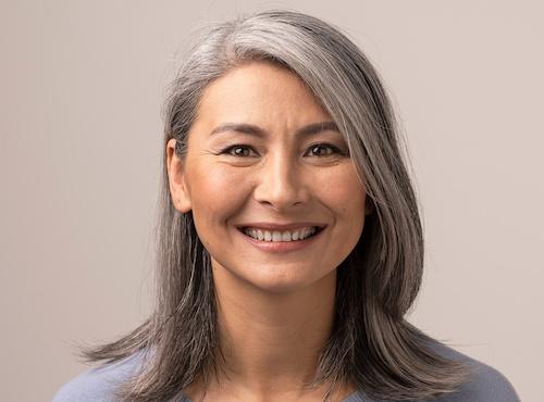 An elderly woman smiling after getting Dental Crowns & CEREC Crowns in Champaign, IL