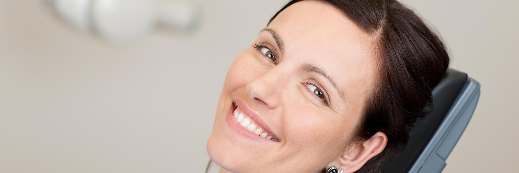 Woman smiling in treatment chair at dentist near me Champaign-Urbana