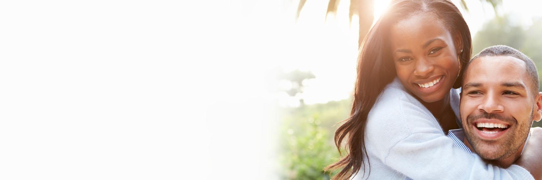 Couple smiling outside in Noel Park in Champaign