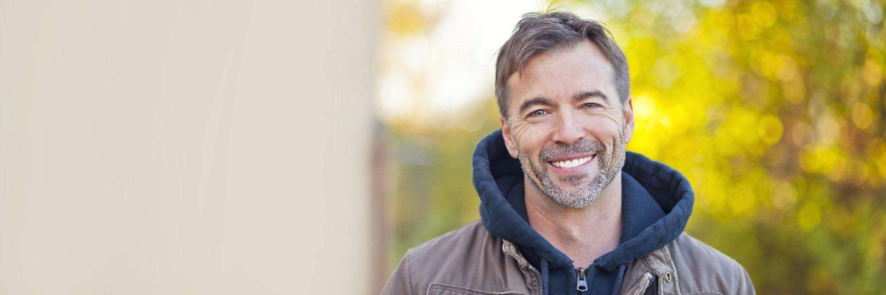 Man wearing a dental bridge smiling in Champaign, IL