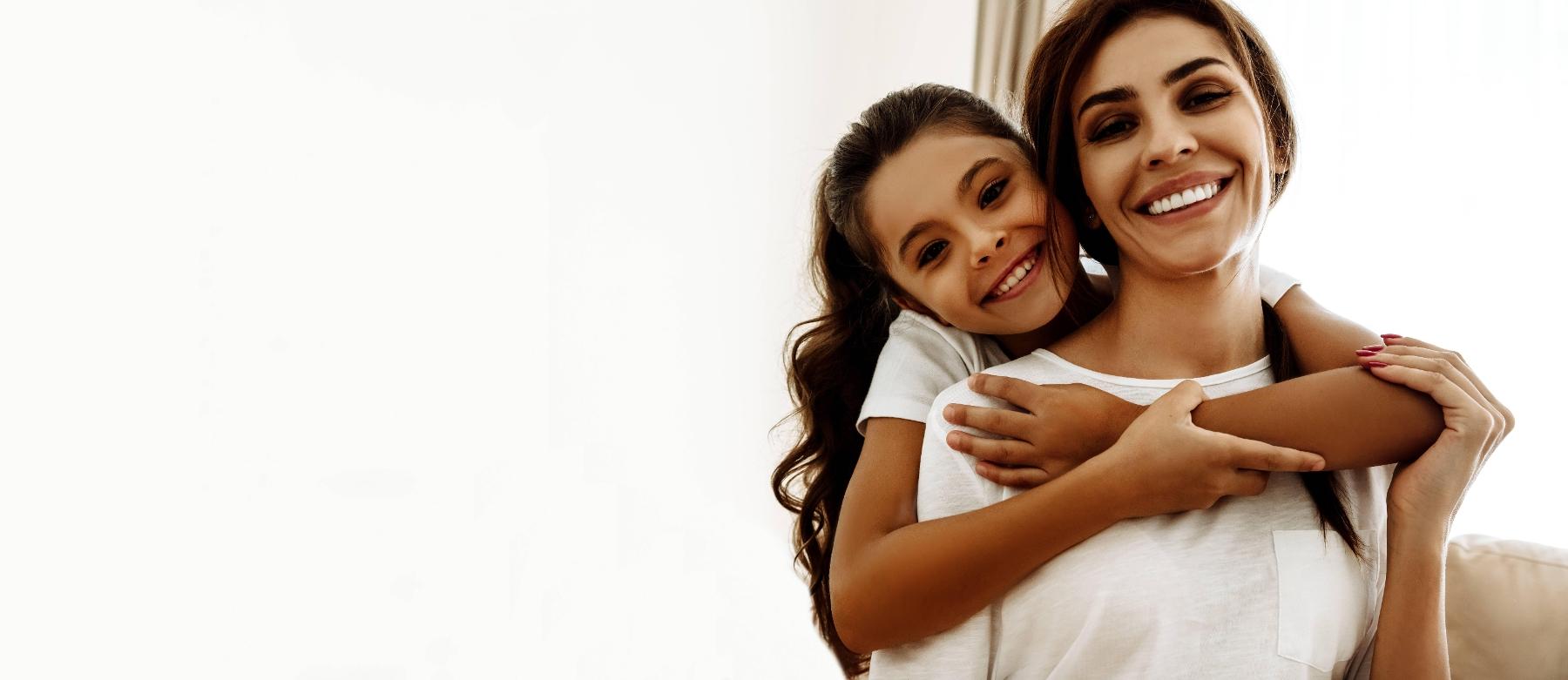 Mother and daughter smiling at dentist office in Champaign IL