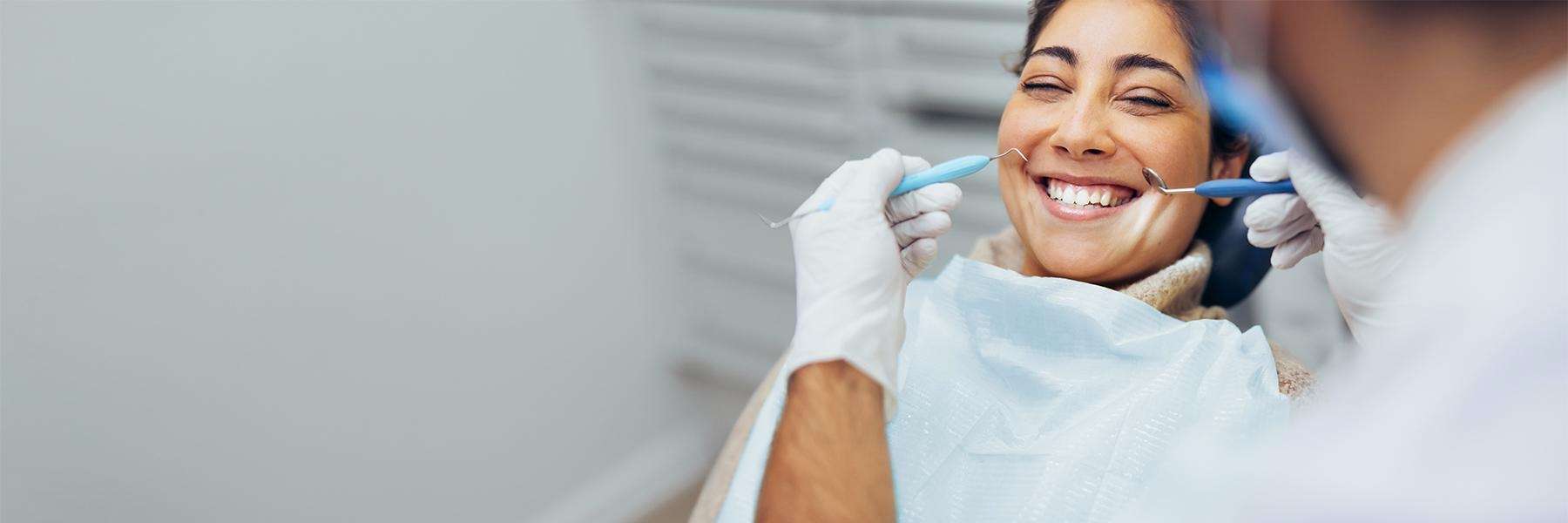 Woman smiling after emergency dental care near me Champaign, IL