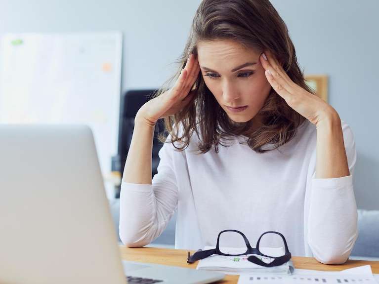 woman with headache from having sleep apnea