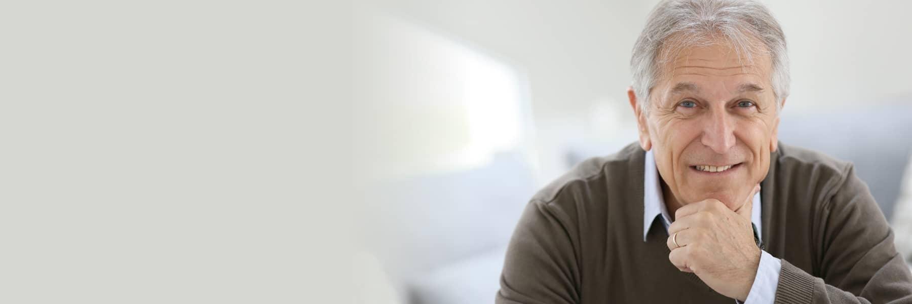 Patient with dental crowns smiling at Champaign dentist office