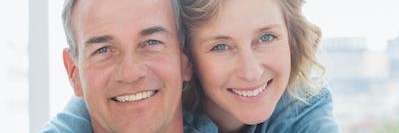 Couple smiling at cosmetic dentist in Champaign, IL