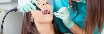 Woman getting treatment at dentist in Champaign, IL