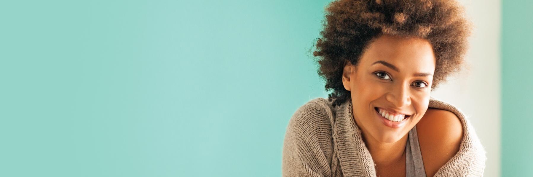 Patient smiling wearing dental crowns in Champaign, IL