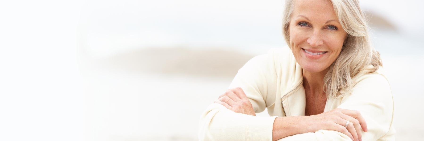 Older woman smiling wearing dentures near Urbana IL