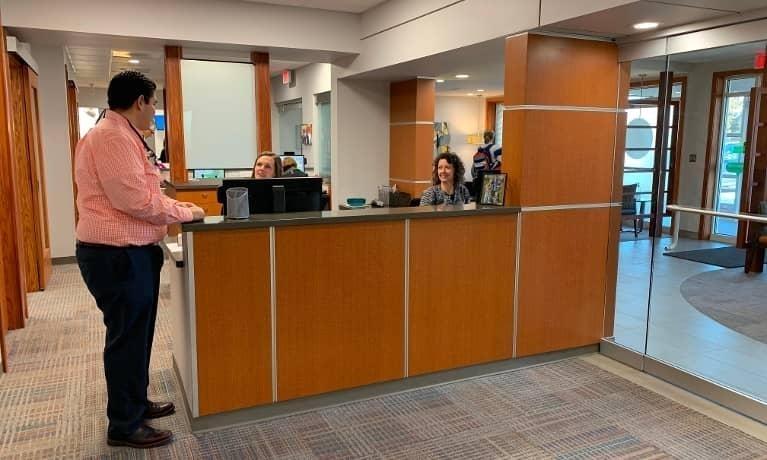 Front Desk Dr. Cesar Alburez at front desk of Champaign, IL dentist office