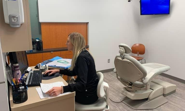 Patient Room Hygienist working on computer at dental office in Champaign IL