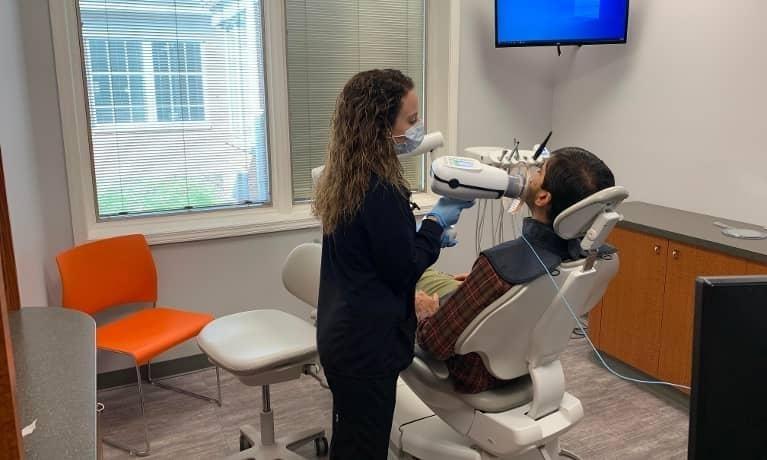 Patient Room Dental hygienist examining patient at Anderson Dental in Champaign